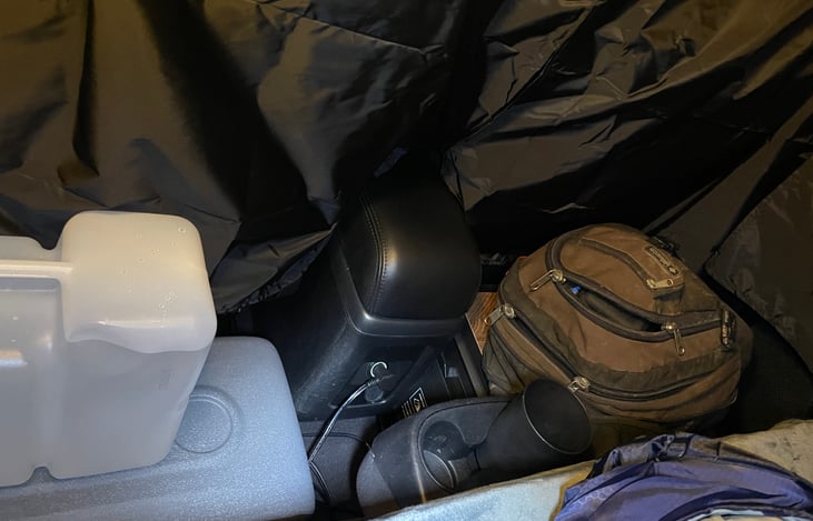 Shown with gear, cooler and camping box stowed for the night behind the front seats.  The privacy curtain sets up in minutes.