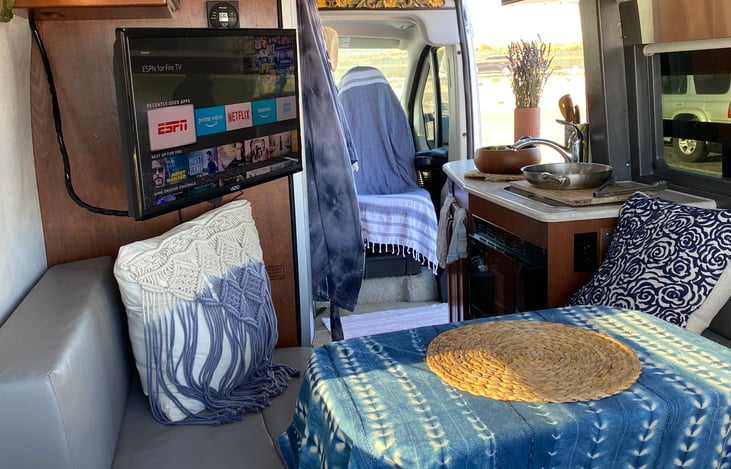 Lounge area with memory foam couch, dining table, smart tv, dvd player & dvds