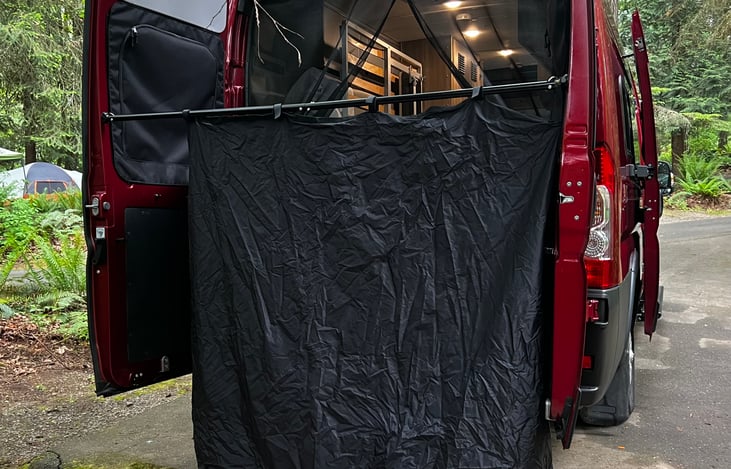 Rear shower curtain set up. You can take a shower, use as a changing area, or close the rear screens for a nice PNW breeze while you sleep