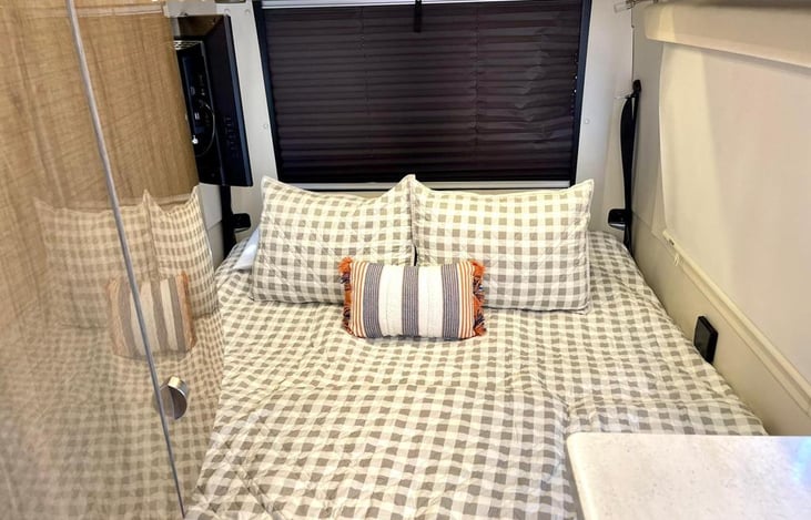 Rear sofa that converts to a queen-size bed. Bedding is included in the booking. This is a standard queen.