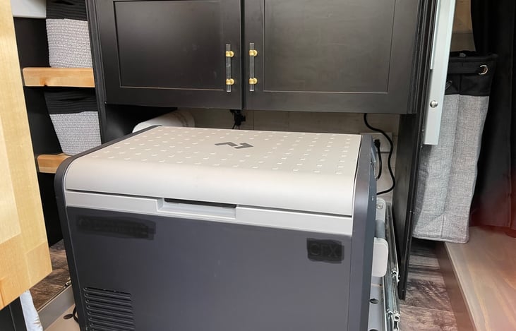 Fridge slides out from under cabinets for easy access.