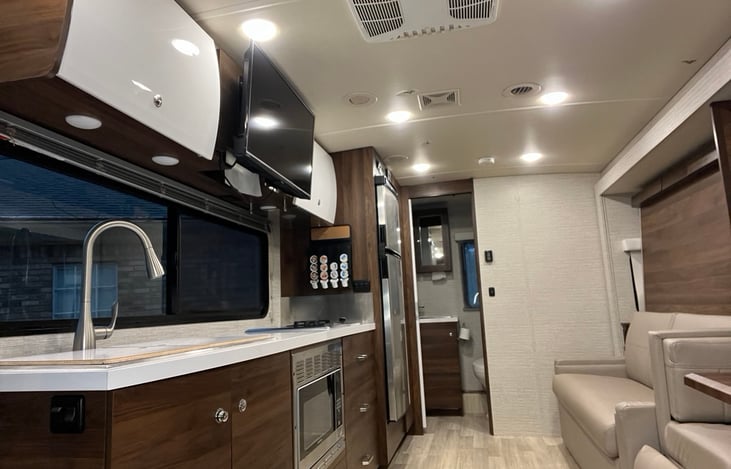 Spacious interior with slide out. Sofa converts to Murphy bed. 32" Smart TV with DVD player. Large overhead cabinets. Coffee brewer with pods, included.