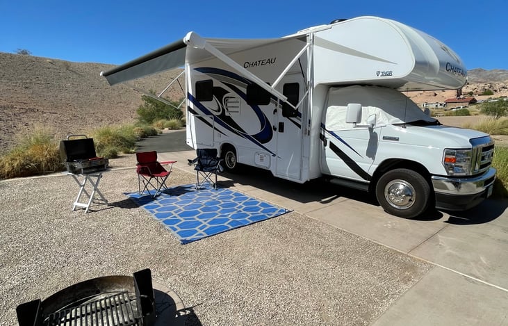 Electrical awning with LED lighting. Grills and stoves are available as an add-on. Windshield privacy cover and outdoor rug included.