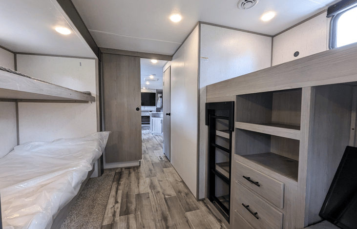 Cozy private bunkhouse in the back of the camper sleeps 4. Multiple windows for ample natural light.