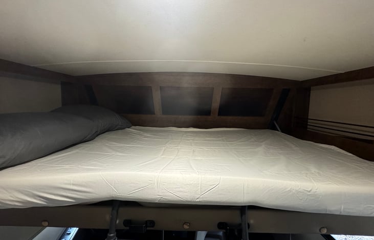 Bed above driver seat.