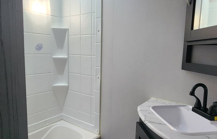 Bathroom with a Lil walk in shower