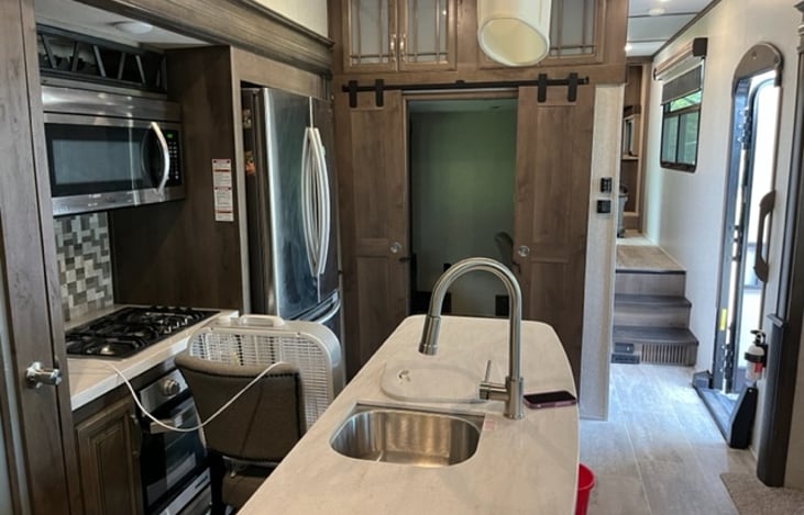 Full size stove, oven, microwave, refrigerator with ice maker.