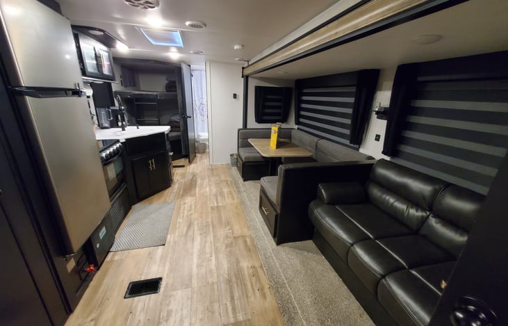 Both the dining table and couch fold down/out to make additional beds. Additional bedding will be provided with number of guests just so you don't have to bring any with you.