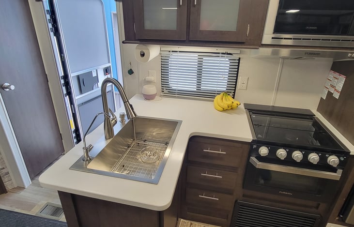 Upgraded larger stainless steel sink and faucet, filtered water faucet.