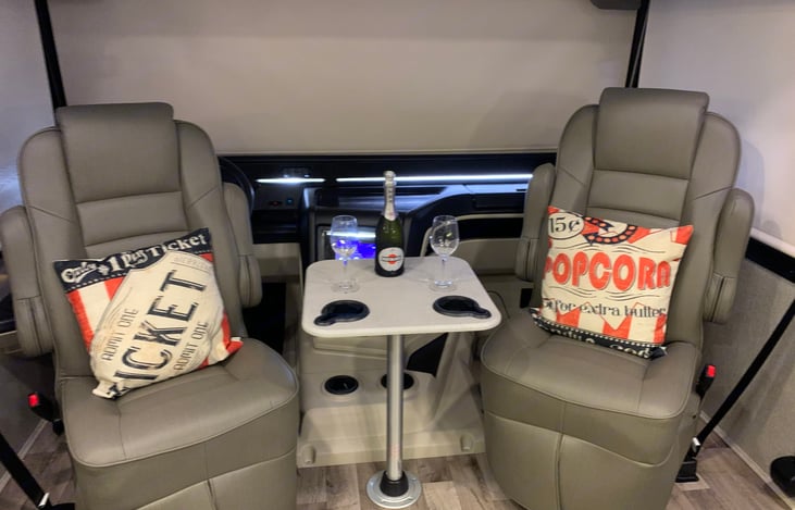 Driver and passenger seat swivel. Enjoy a film with the family in the theater style seating area!