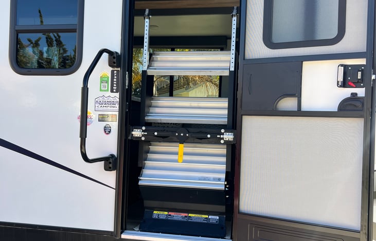 Entrance into trailer with stairs shown in the stored position.