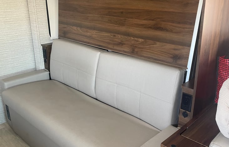 Sofa with storage underneath, Murphy bed is behind it.