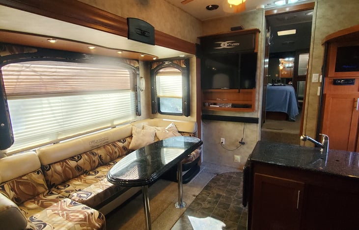 Huge seating/theater area with dinette table. Makes into Queen bed. Separate Power Inverter for 12V Entertainment center operation.