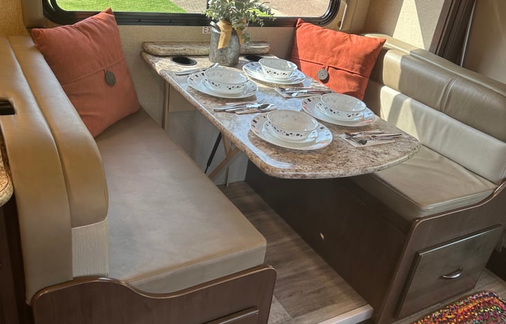 Dining room table staged with place settings.