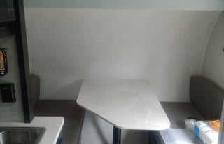 Yes it has a bathroom. Small easy to tow 3200lbs.