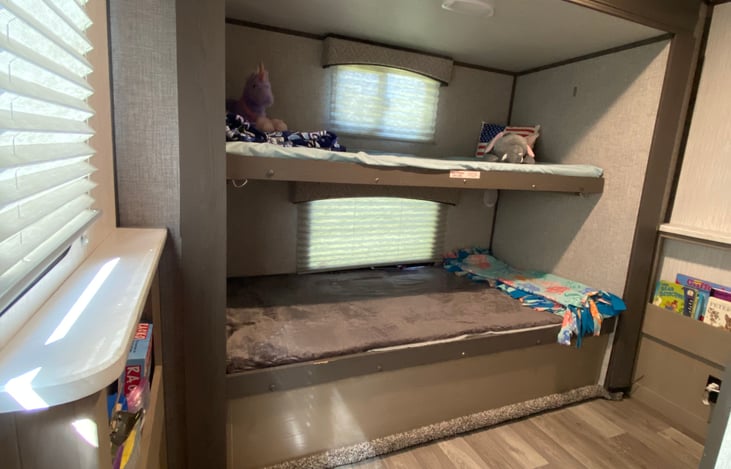 The kids (or adults) bunkroom. A full size bottom bunk with a twin top bunk. The bottom bunk lifts to provide storage! The side shelves have coloring material, kids books and some games as well.
