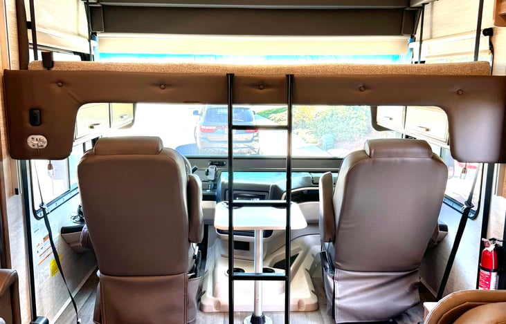 Lower the bed above the captain's chairs to sleep two people.