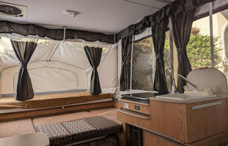 Angled view with view from the window. Window shades are open.