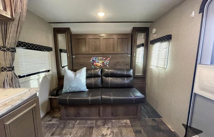 Front of the RV with couch that converts to the main sleeping bed.