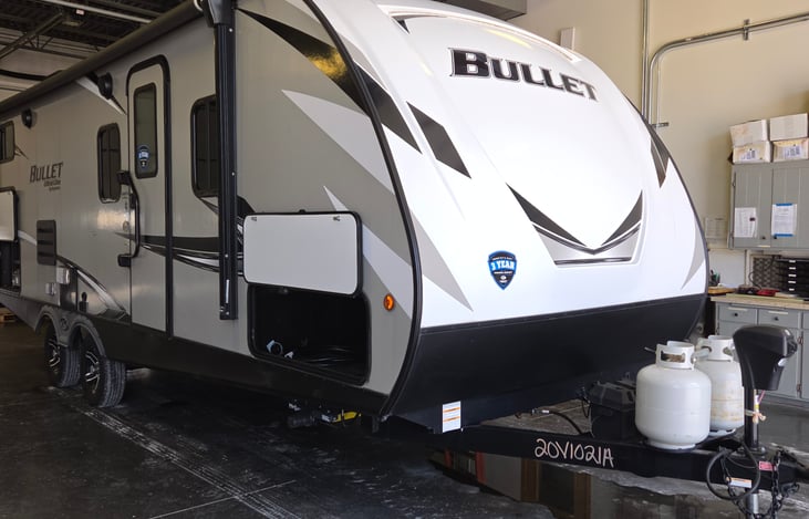 Front of camper with trailer hitch. Large pass through storage area.