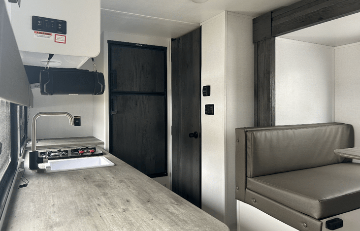 Full size fridge with freezer, bathroom and full kitchen with stove top and microwave