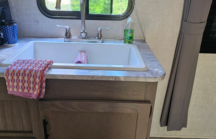 Double sink with dish soap, dish clothes, and dish towels included