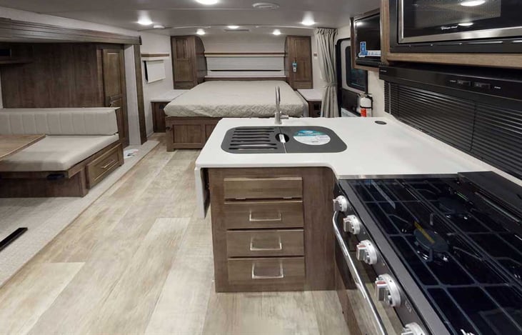 - the stove has a glass top to provide more counter space
- there is a flip-up counter to the left of the sink