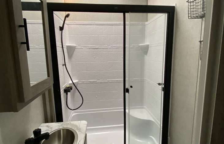 Glass shower door is removed with a shower curtain instead for easier cleaning and transport. Shower curtain is replaced between booking.