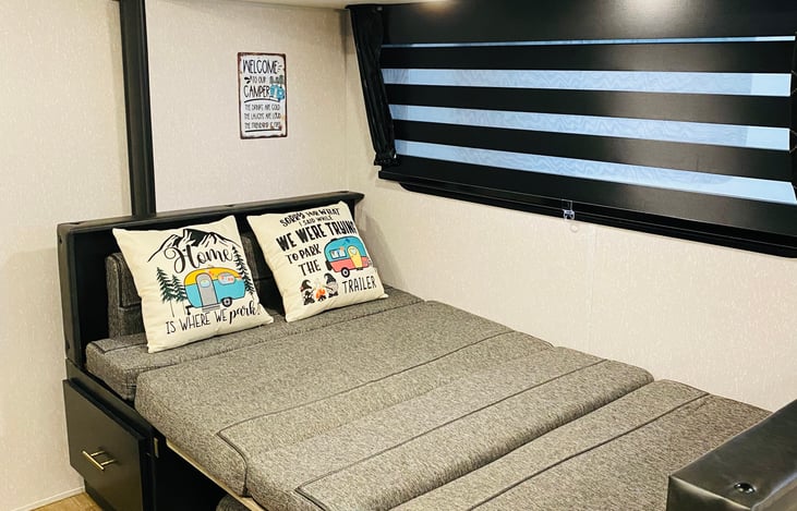 The dining table converts into a comfortable full-sized bed! (extra linens provided if needed).