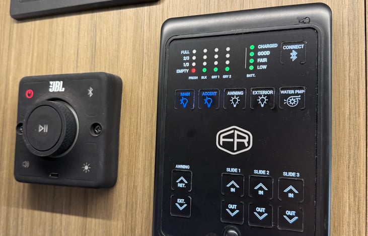 Control panel with Bluetooth JBL system and controls. Speakers inside and out.