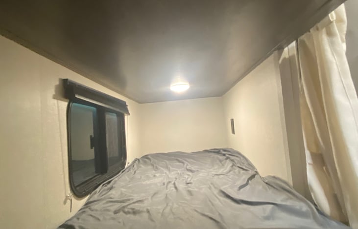 View of bunk bed with window and USB plug ins in each.