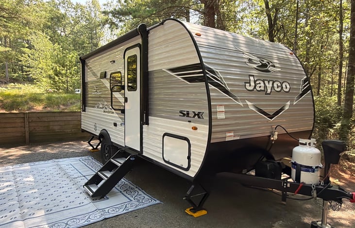 Camper shown delivered and set up at Hill and Hollow campground in Pentwater MI.