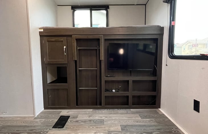 Entertainment area with large storage cabinet.