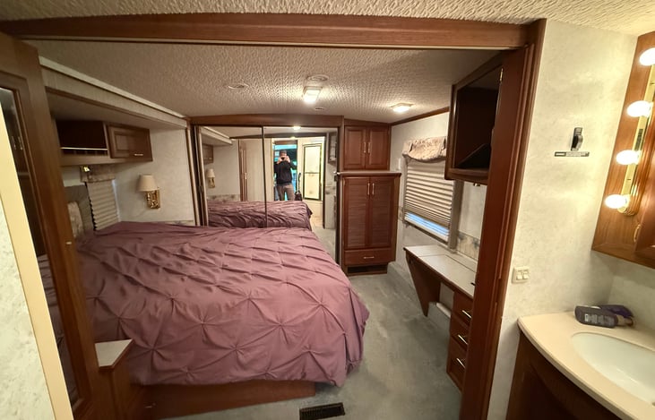 master bedroom with 2 large closets, has a pull out partition to close off from the bathroom area.