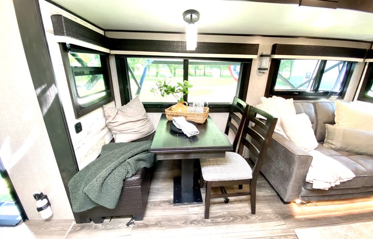 large dining area with bench.  table extends for additional seating