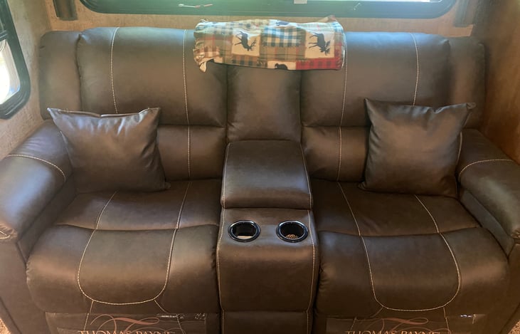 Recliners with center storage and cup holders