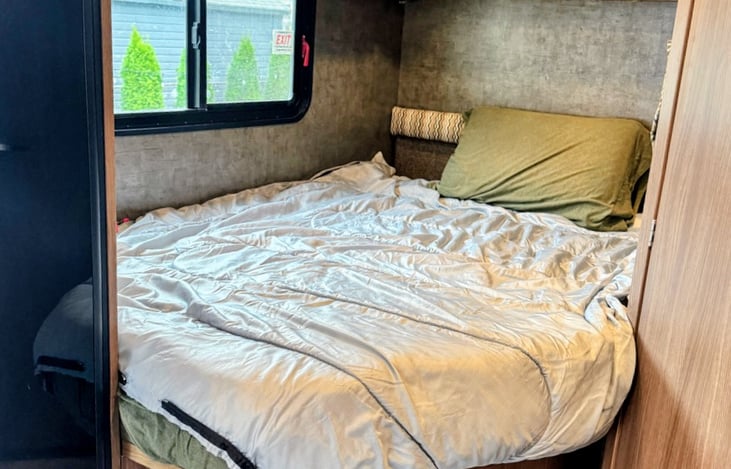 We provide linens, comforter and pillows for the back queen sized bed and the loft bed. This bed is extremely comfortable!