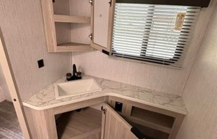 In the bathroom you have several different cabinets to use for easy storage of hygiene items to towels and TP (travel Trailer Approved TP).