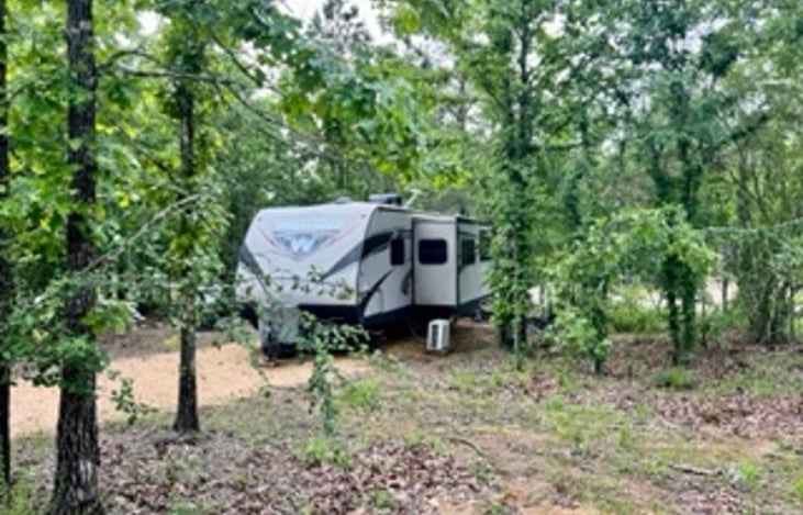 We have a spacious area for our camper in the RV Park with surrounding trees for added privacy.