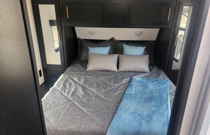 Queen size bed with a door for privacy and an upgraded mattress!