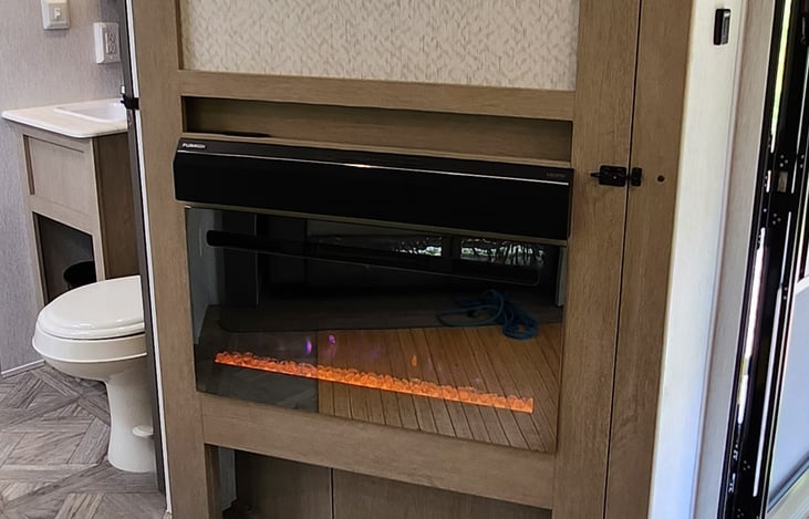 Fireplace & there will be a TV above can be used when you are in the living space & kitchen.  Then swing the door fully open so the fireplace and TV can be used while you are in the bedroom.