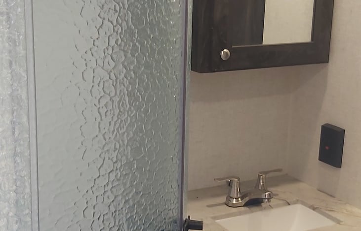 Bathroom vanity, sink combo.  Full size shower with sunroof.
