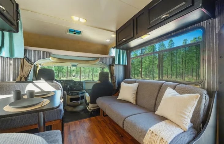 Family friendly and festival ready — enjoy this cozy sofa setup in your Thor Majestic 28A, perfect for hanging out after the fun