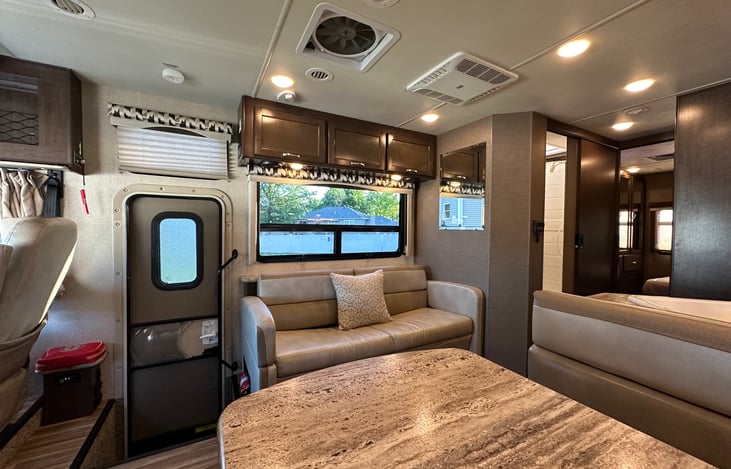 Living area with one sofa that turns into a bed and dining table that also converts to a bed