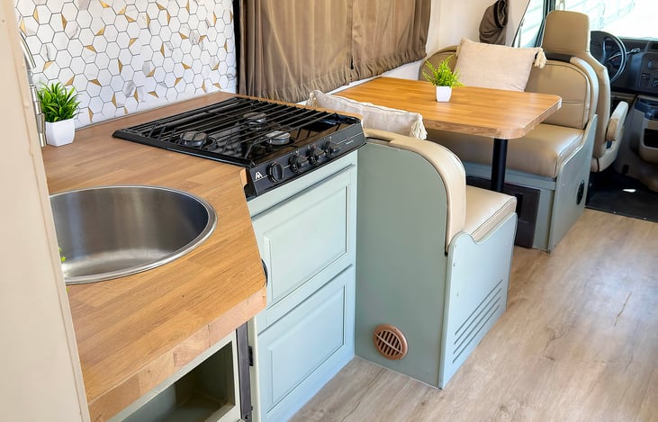 Cook on the road in this full kitchen setup — part of a Las Vegas glamping RV rental that’s festival friendly, pet friendly, and perfect for family adventures or events