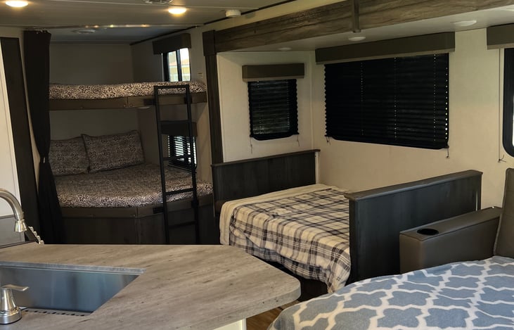 Showing sleeping accommodations in addition to queen bed. 2 full size bunks and 2 pull-out over sized twin beds.