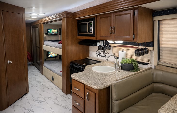 Fully equipped kitchen with stove, oven, and microwave—fully stocked at no additional cost with plates, bowls, cups, flatware, pots, pans, and more