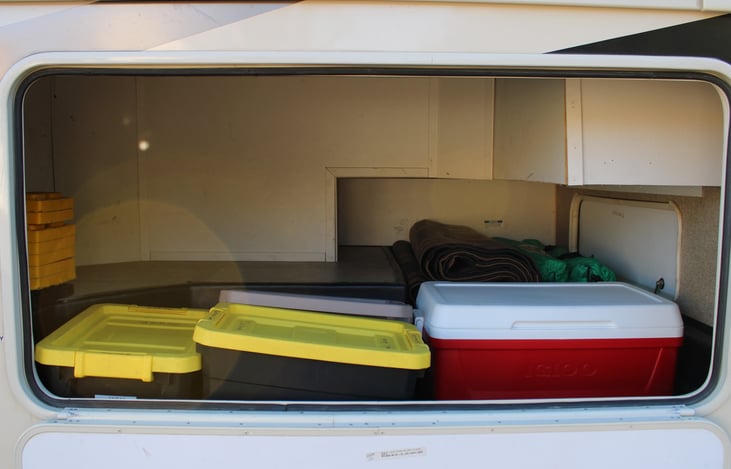 Roomy outside storage, that fits coolers, camping chairs, or your luggage. All necessary equipment to operate the RV is neatly organized in labeled bins for easy access.