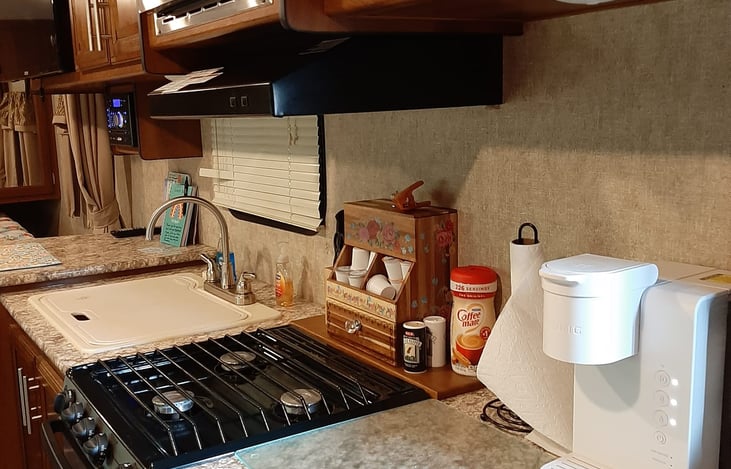 Furnished kitchen with Keurig, pots and pans, and cooking utensils.  Handy Pantry with additional supplies.