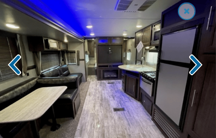 Large space, TV, kitchen including sink, stove, microwave and fridge.